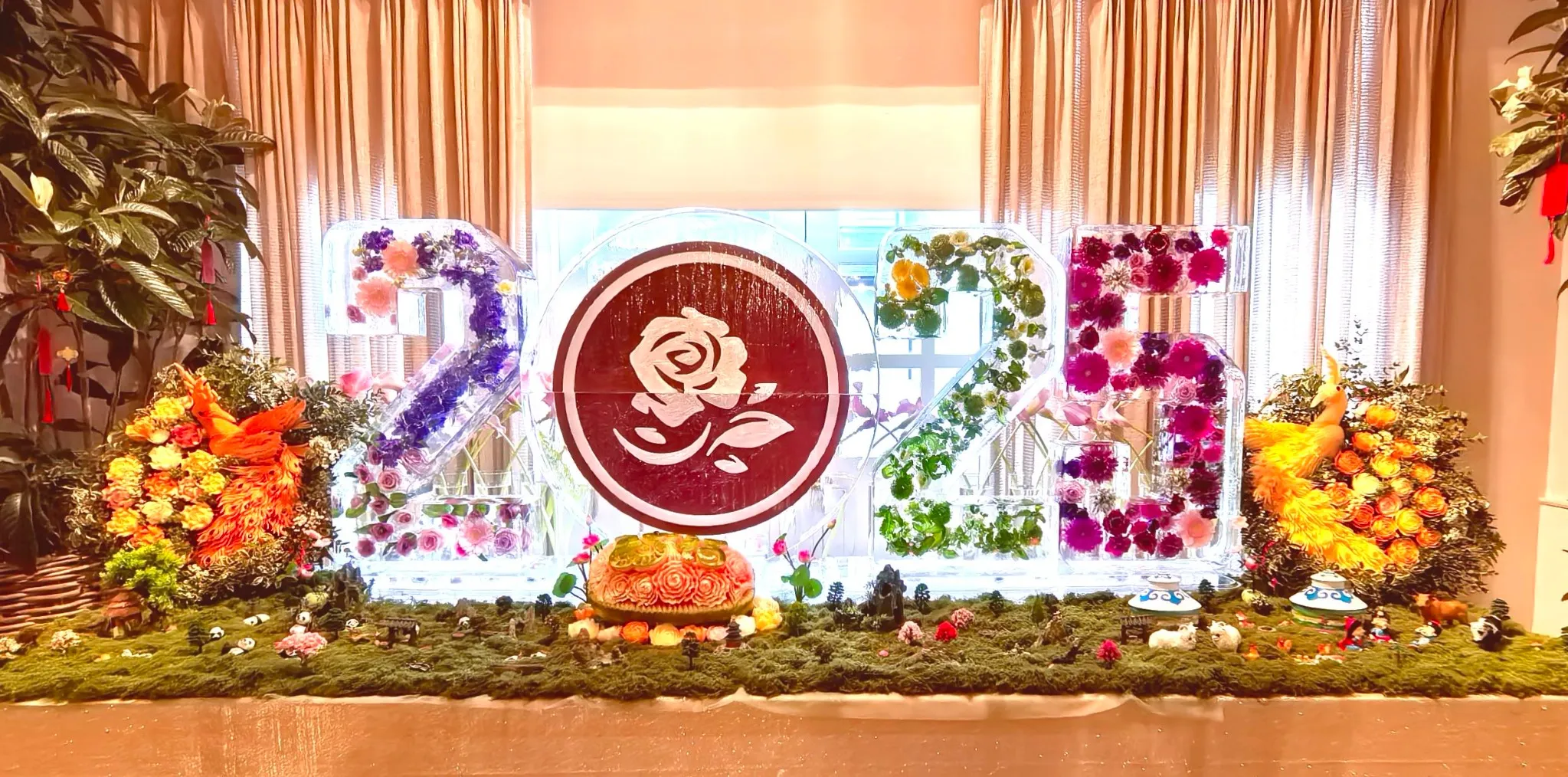 The completed 2025 floral installation in front of the windows, flanked by festive arrangements