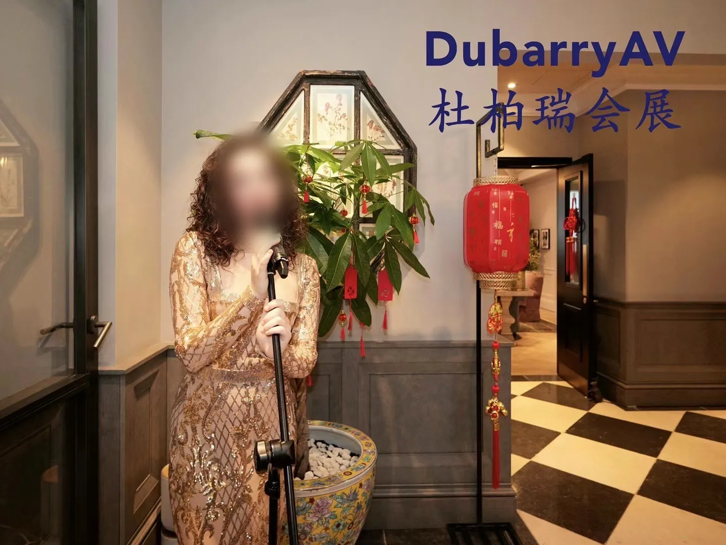 A live singer performing beside red lanterns and a lucky bamboo plant