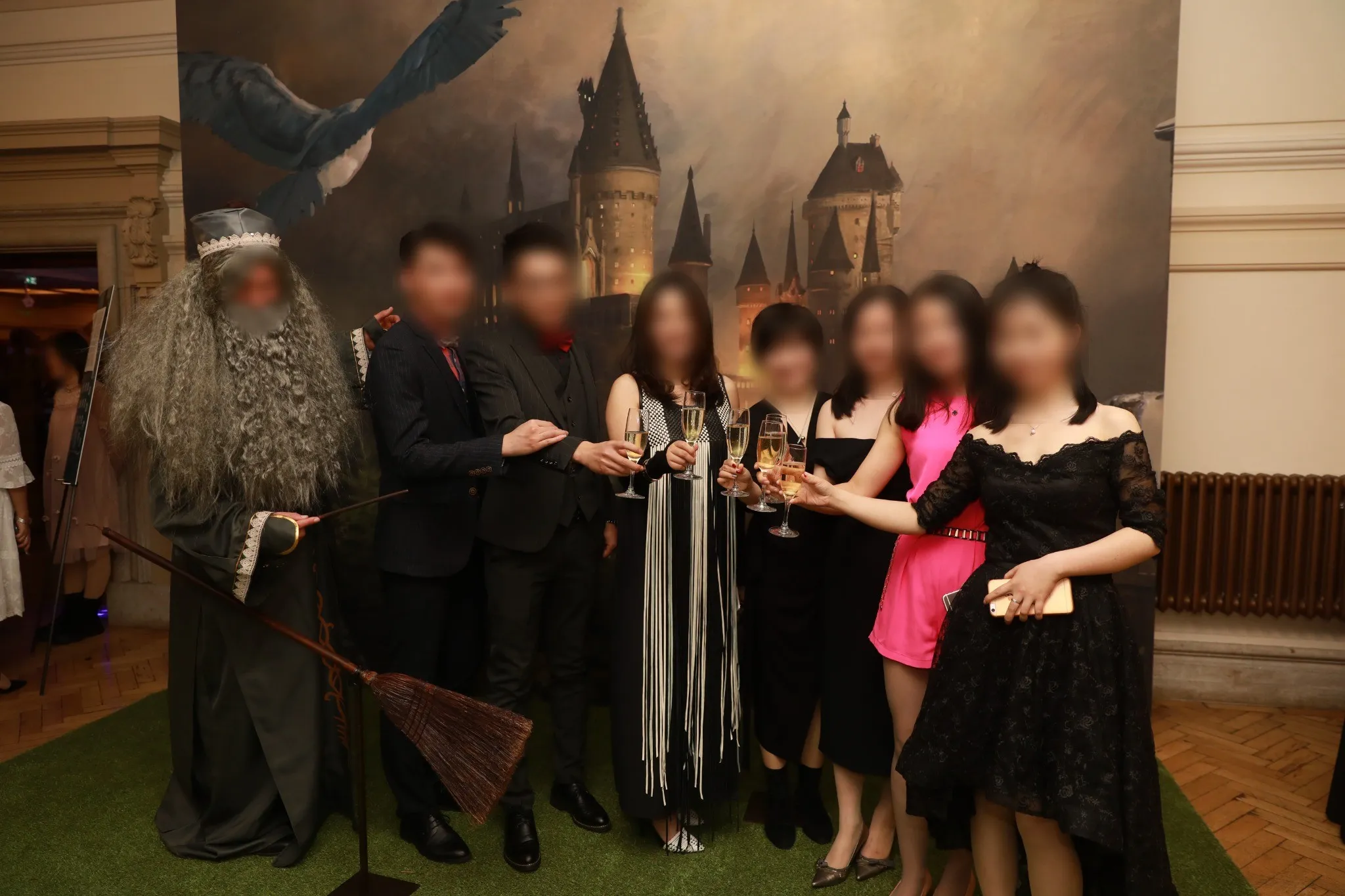 Guests in evening dress with a costumed character at the themed welcome set