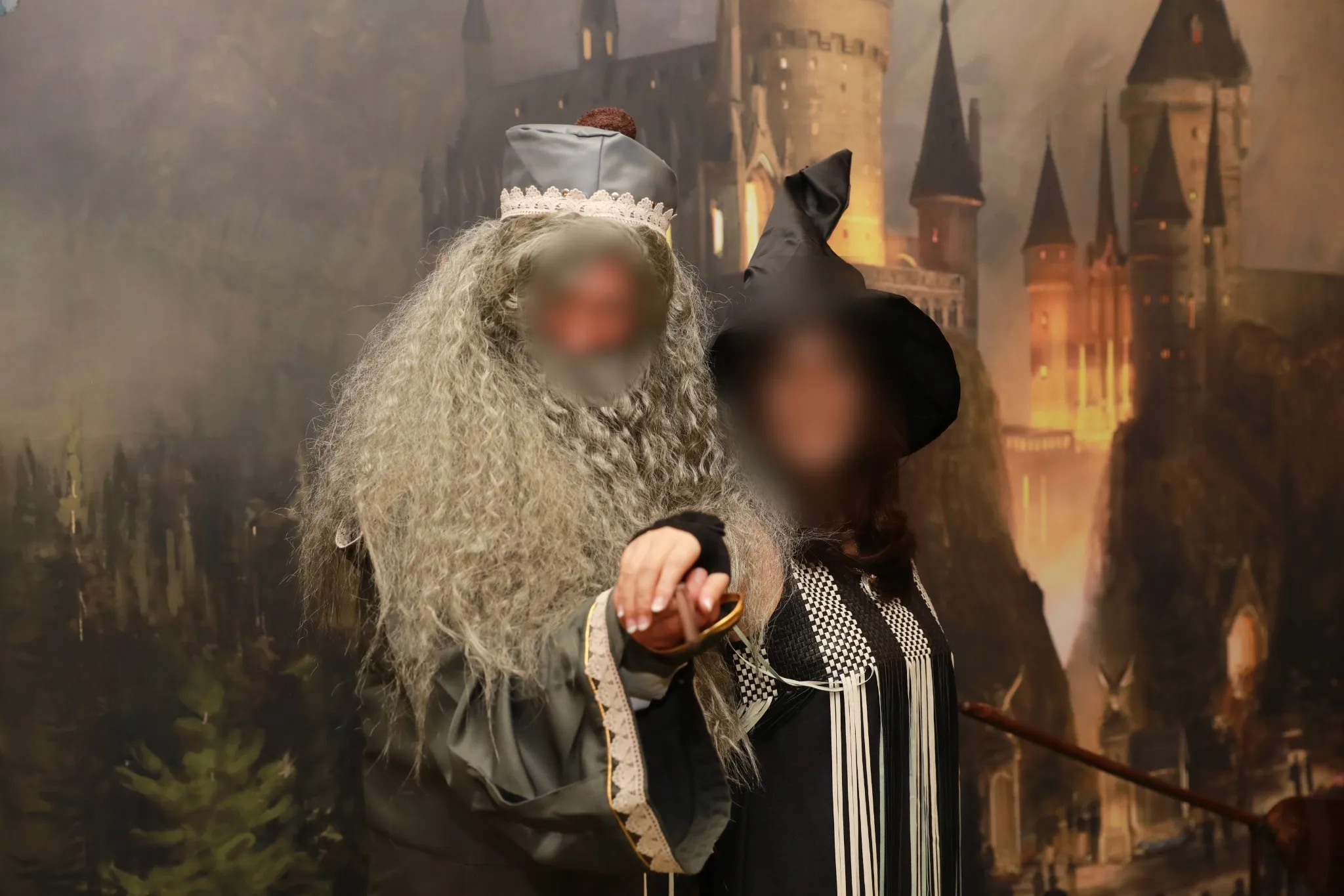 Two costumed characters photographed in front of a painted castle backdrop