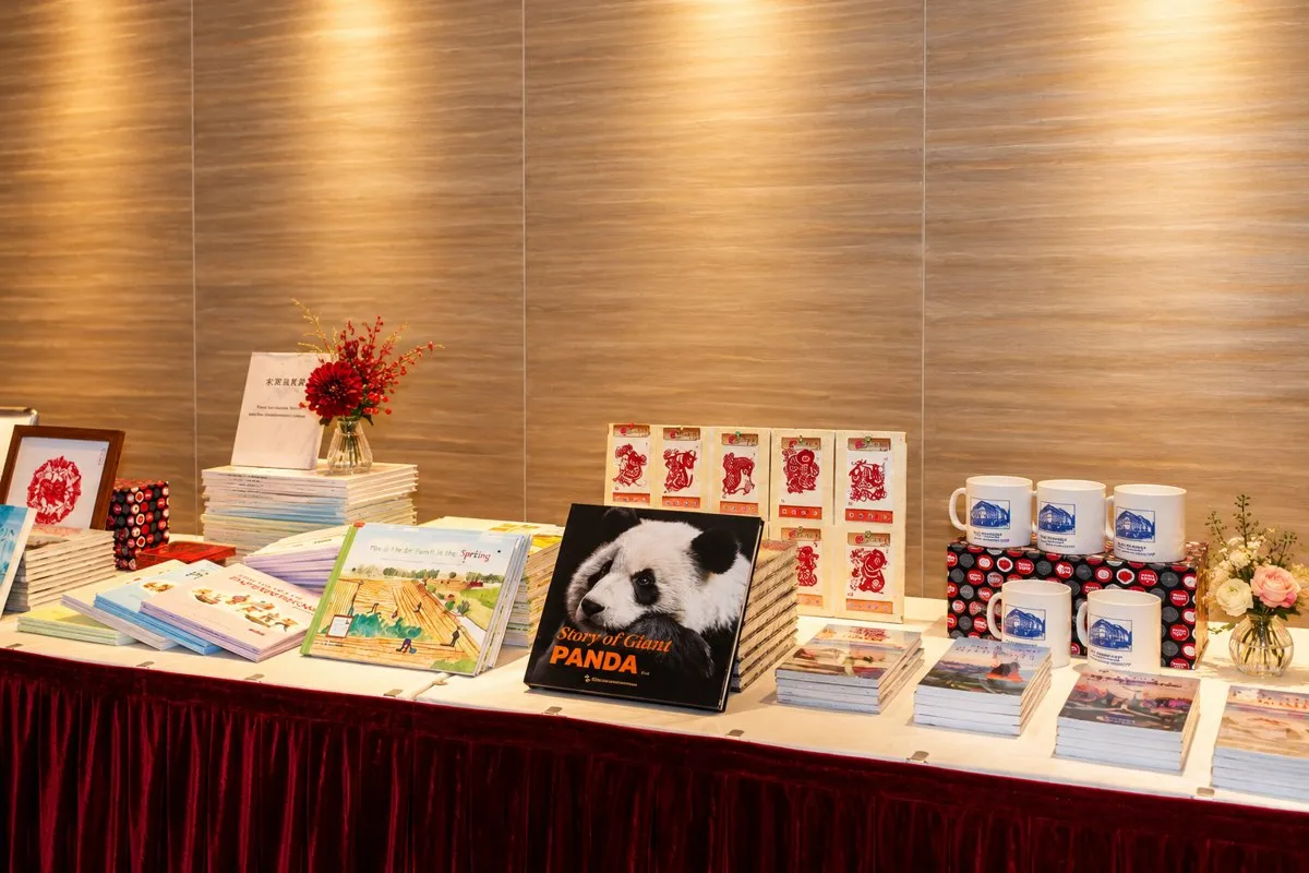 A cultural display table with books, paper cuttings and gifts