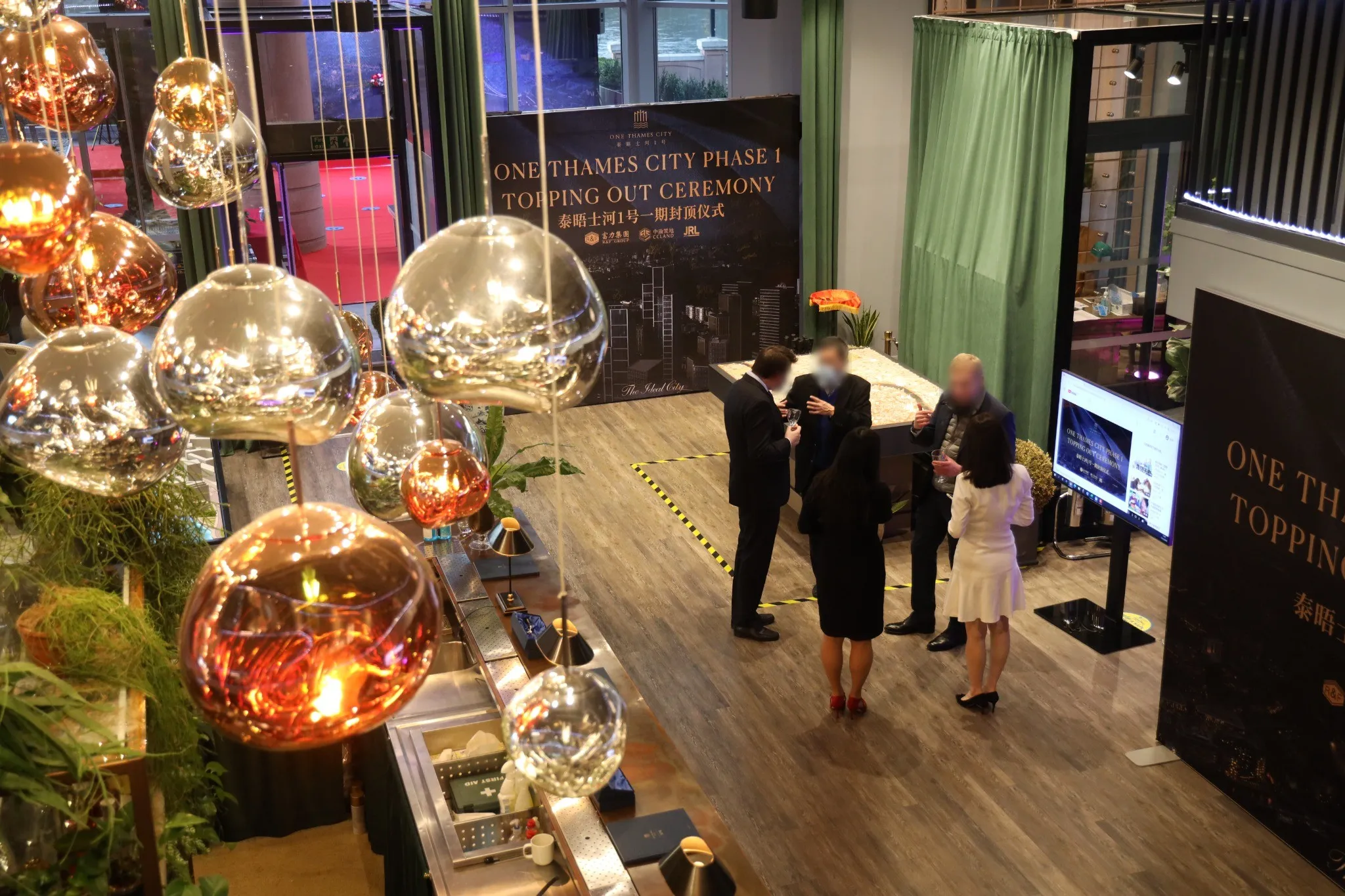 The reception space dressed with copper globe lighting and branded panels
